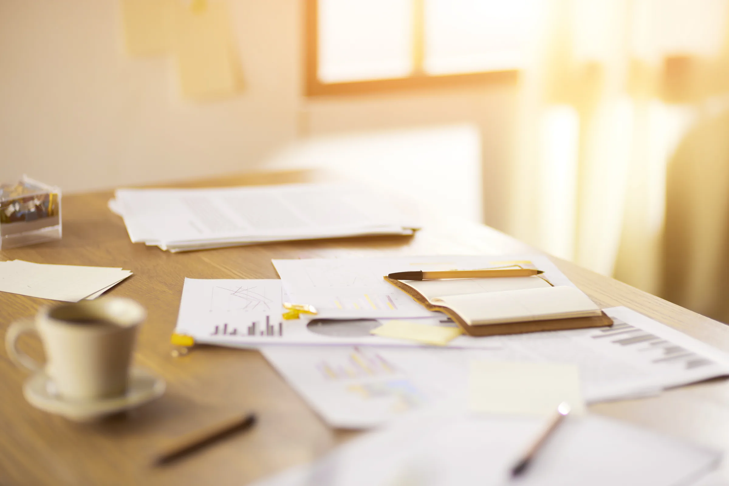 A desk of papers and figures with nobody at it